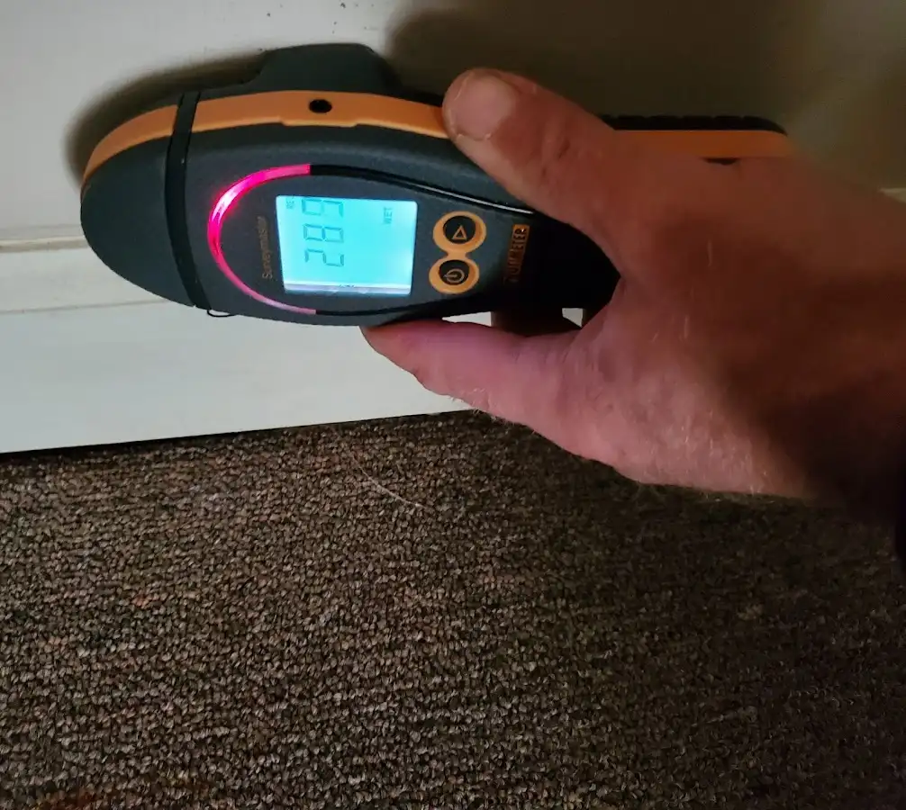 Moisture detection at baseboard during Storm Damage Restoration in Merrydale